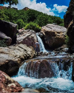 Waterfall cascading over rocks in the green Atlas foothills